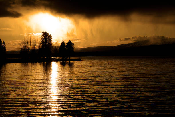 sunset storm clouds over lake pine trees wilderness - pine sunset night sunlight imagens e fotografias de stock