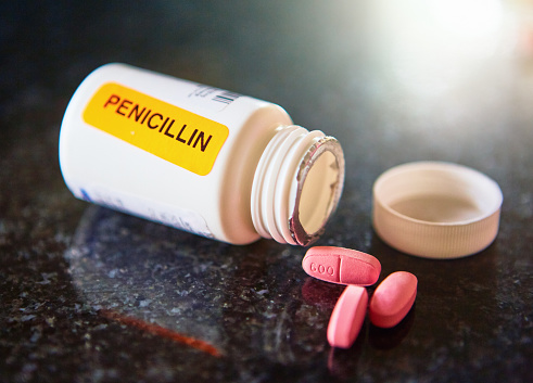 Pharmacist has stuck a bright orange sticker on a container of antibiotics to draw attention to the fact that they contain penicillin, to which some people are allergic.