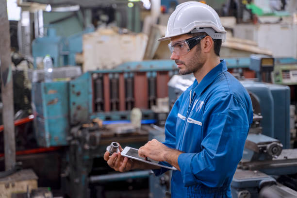 istock Blue collar worker with co worker at factory. 1400643164