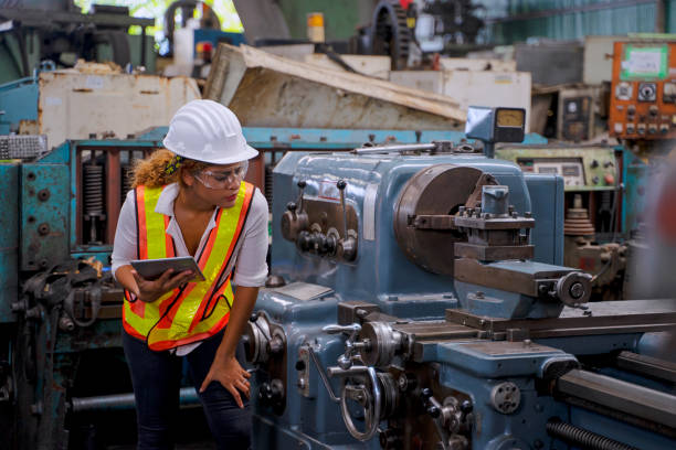 istock Blue collar worker with co worker at factory. 1400643196