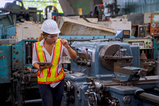 istock Blue collar worker with co worker at factory. 1400643206