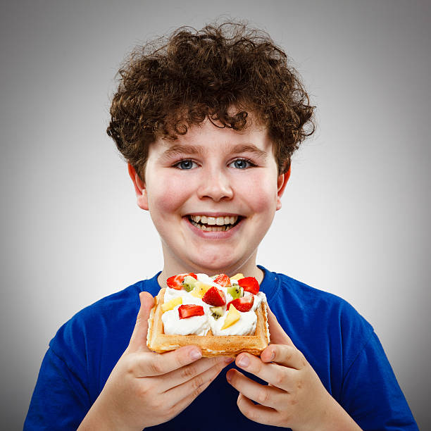 Boy eating fruity cake
