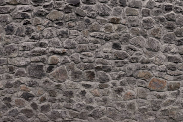 istock Grey texture of a natural stone. Stone wall as a background or texture. An example of masonry as a cladding of external walls. 1400644278