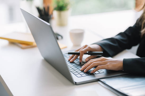 istock Businesswoman sitting using laptop computer on desk in the office. 1400644329