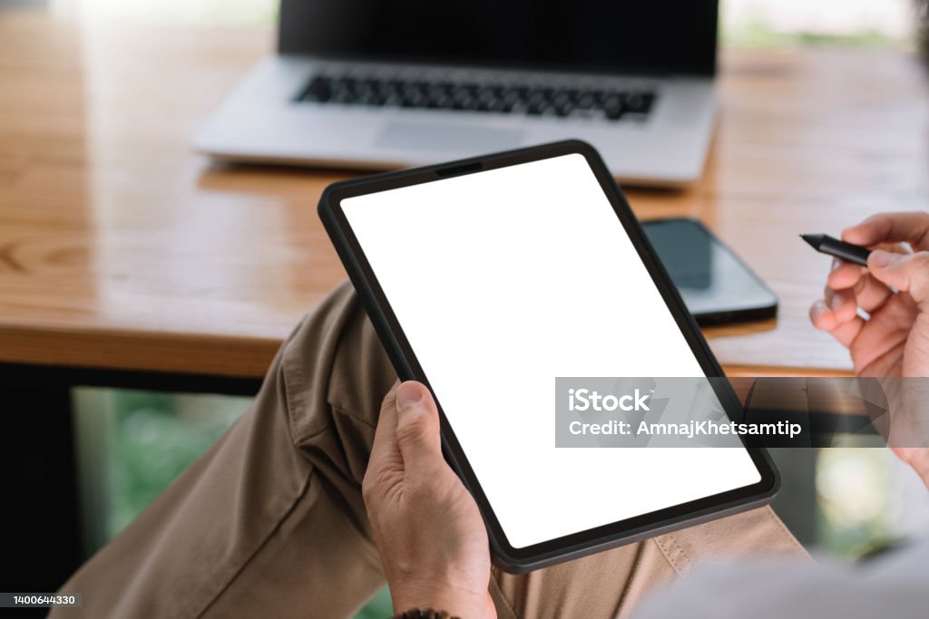 Close up view of man using tablet blank white screen for text message or information. Digital Tablet Stock Photo