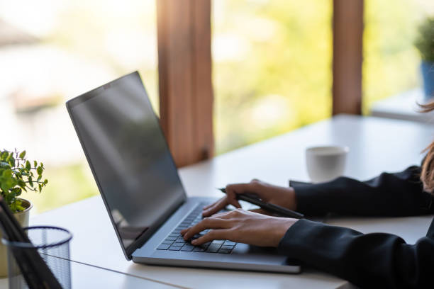 istock Businesswoman sitting using laptop computer on desk in the office. 1400644341