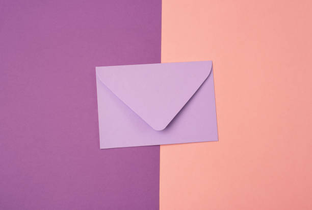 istock Lilac envelope on pink and purple background. 1400644553