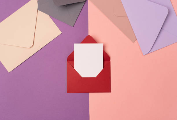 istock Red envelope with a blank sheet of paper with some more envelopes. 1400644618