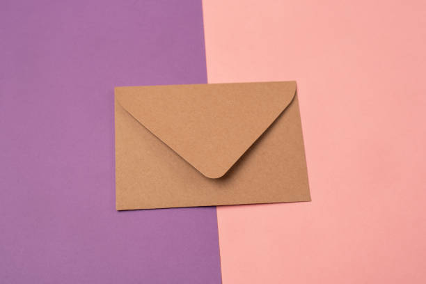 istock Craft envelope on pink and purple background. 1400644622
