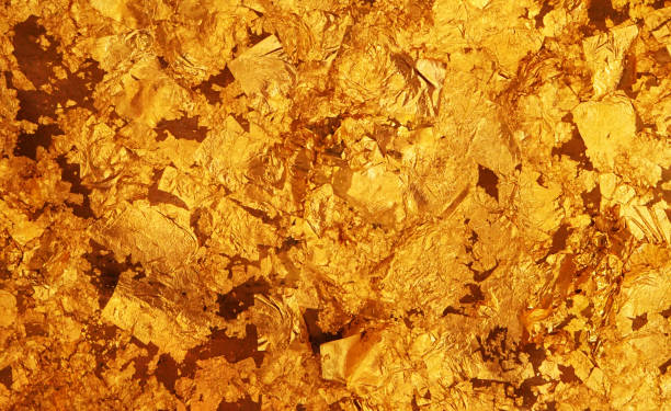 istock The dark gold leaf foil texture background. 1400645396