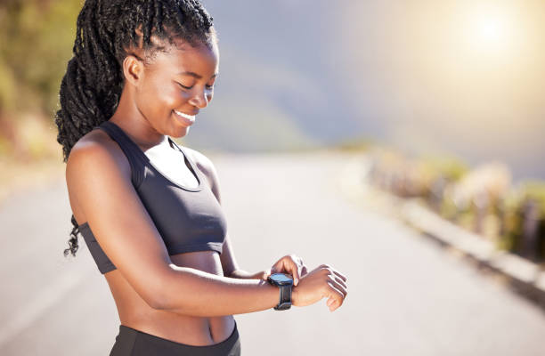 istock One beautiful african american female athlete checking her smartwatch while exercising outdoors. A young athletic woman smiling while tracking her progress on a fitness watch during her workout 1400645432