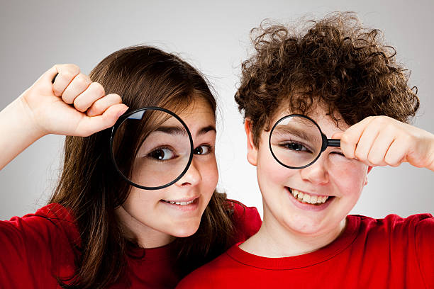 istock Girl and Boy holding magnifying glass 140064650