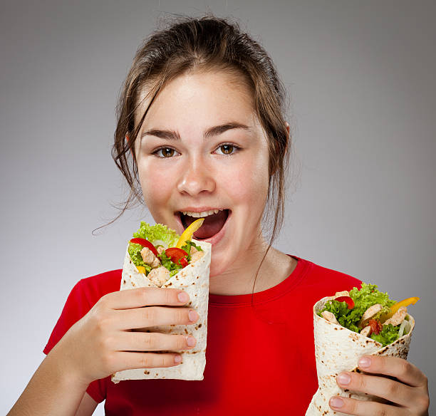 istock Girl holding sandwiches 140064676