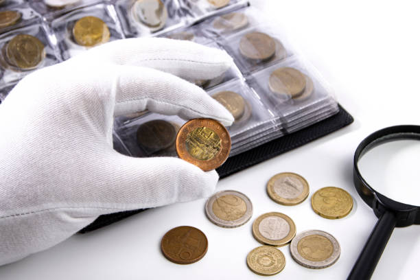 a collector in white gloves examines a coin, close-up. - coin collection imagens e fotografias de stock