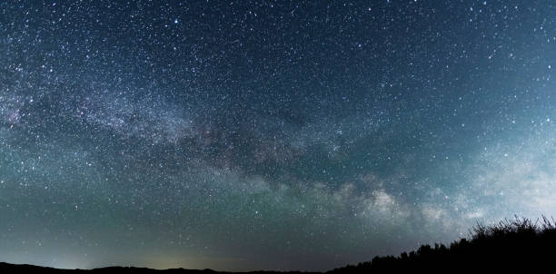 istock Beautiful bright milky way galaxy at the night sky. Astronomical background. 1400650026