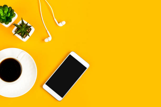 istock Morning coffee, notebook, mobile phone, plants on a yellow background. Copy space. Top view. Business yellow background. Flat lay, concepts ideas 1400650069