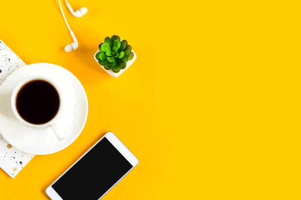 istock Morning coffee, notebook, mobile phone, plants on a yellow background. Copy space. Top view. Business yellow background. Flat lay, concepts ideas 1400650071
