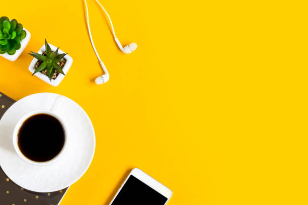 istock Morning coffee, notebook, mobile phone, plants on a yellow background. Copy space. Top view. Business yellow background. Flat lay, concepts ideas 1400650075