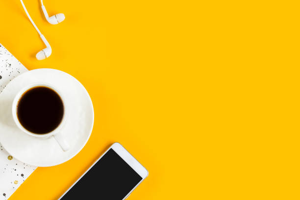 istock Morning coffee, notebook, mobile phone on a yellow background. Copy space. Top view. Business yellow background. Flat lay, concepts ideas 1400650078