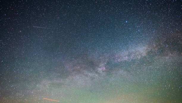 istock Beautiful bright milky way galaxy at the night sky. Astronomical background. 1400650121
