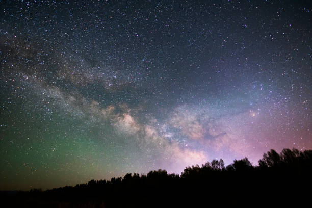 istock Beautiful bright milky way galaxy at the night sky. Astronomical background. 1400650698