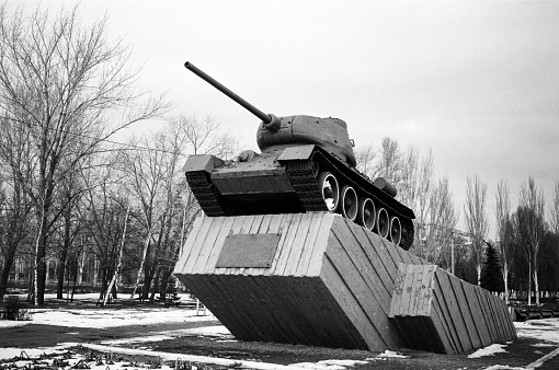 Soviet victory tank T 34-85 stands on a pedestal as a monument. The photo was taken on black and white photographic film Ilford