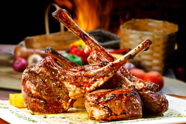 roasted lamb rib, grilled over coals roasted lamb rib, grilled over coals rack of lamb stock pictures, royalty-free photos & images