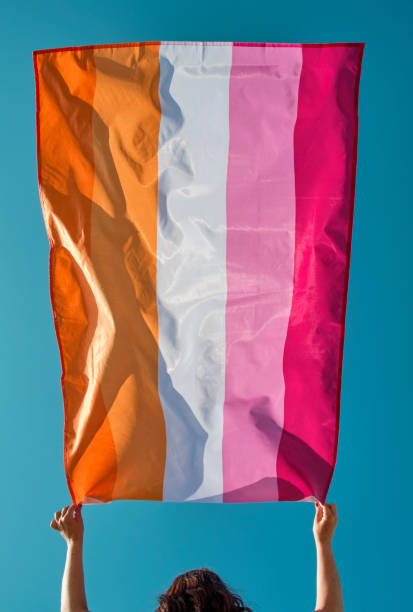 istock holds a lesbian pride flag above her head 1400651961