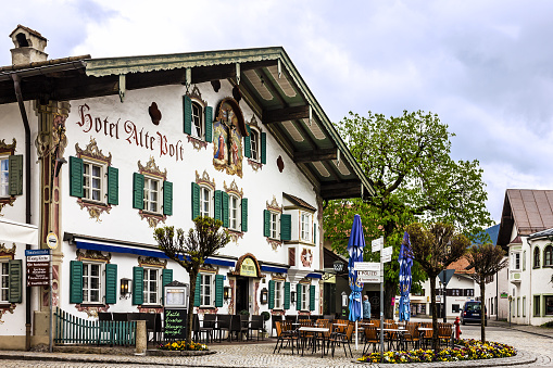 Bavaria, Germany - May 30, 2022: Painting house in village Oberammergau, Hotel and cafeteria