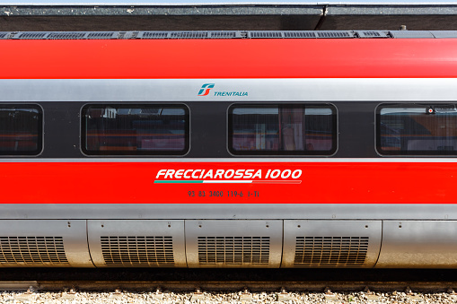 Venice, Italy - March 21, 2022: Rail car with logo of Frecciarossa FS ETR 1000 high-speed train of Trenitalia in Venezia Santa Lucia railway station in Venice, Italy.