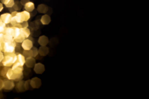 istock Golden blurred bokeh lights on black background 1400655291