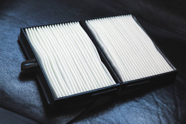 New car air filter on a leather black car seat stock photo