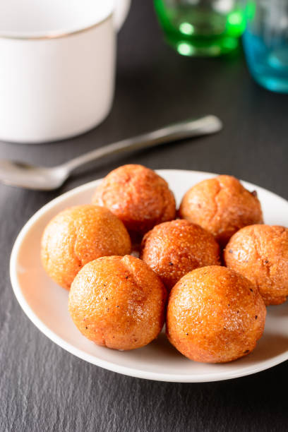 fried semolina balls on a plate fried semolina balls on a plate, served savory treat and light snack for tea time, closeup view of a sweet balls taken in shallow depth of field rawa island stock pictures, royalty-free photos & images