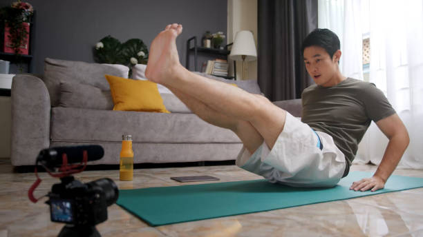 istock Asian man teaching or coaching his online student working out at home. 1400658911