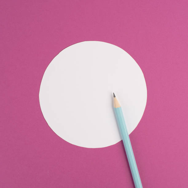 istock Pencils on a pink paper background, white circle frame with copy space for text, minimalism, creative and business concept, pastel colored 1400660818