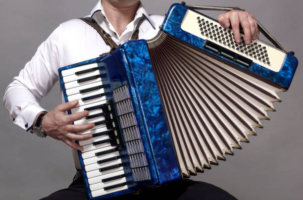 istock blue accordion, played by a man, in the frame only hands 1400662881