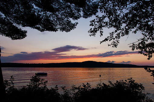 A sunset over Lake Thompson in Maine, taken during the summer.