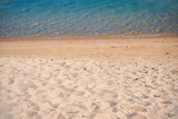istock Seascape with surface of blue sea water with small ripple waves crashing on yellow sandy beach. Travel and vacations concept. 1400664708