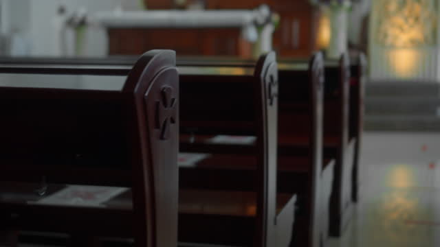 Empty seats in a Catholic church without people
