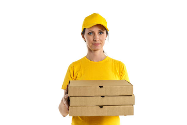 Woman in yellow pizza delivery girl on white background Woman in yellow shade and yellow cap holds boxes, pizza delivery girl on white background woman wearing baseball cap stock pictures, royalty-free photos & images