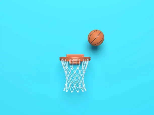 Basketball ball in the hoop on blue color background. Horizontal composition. Isolated with clipping path.