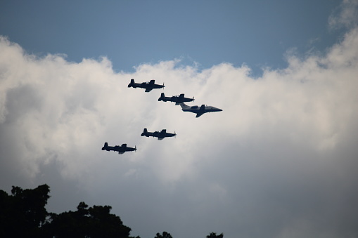 Silhouettes of seven fighter planes with smoke in airshow. Clear blue sky with copy space. Image taken with Hasselblad H3D Camera System and developed from RAW.