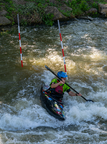 Metz, France - 1 June, 2022: slalom kayaker training on the Digue de la Pucelle slalom course in the city center of Metz