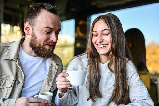Smiling Couple Comparing Different Coffees Ordered In Bar