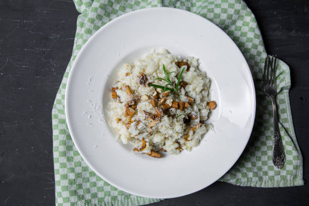 istock Tasty mushroom risotto on black concrete table, top view. 1400667998