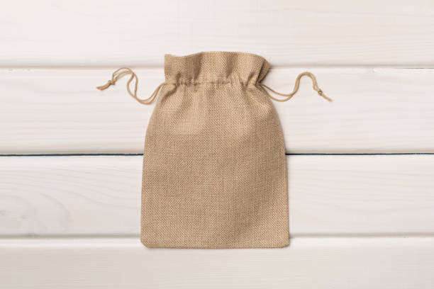 istock Burlap eco sack on wooden background, top view 1400668826