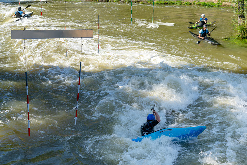 Metz, France - 1 June, 2022: slalom kayakers training on the Digue de la Pucelle slalom course in the city center of Metz