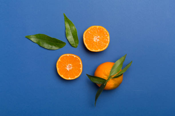 istock Flat lay with fresh mandarines on color background. Top view 1400669254