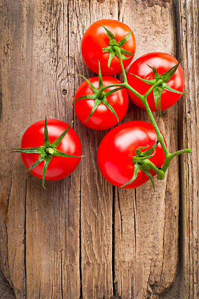istock Fresh tomatoes on vintage wooden table 140066980