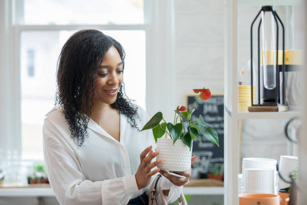 istock Woman holding a potted plant 1400670816